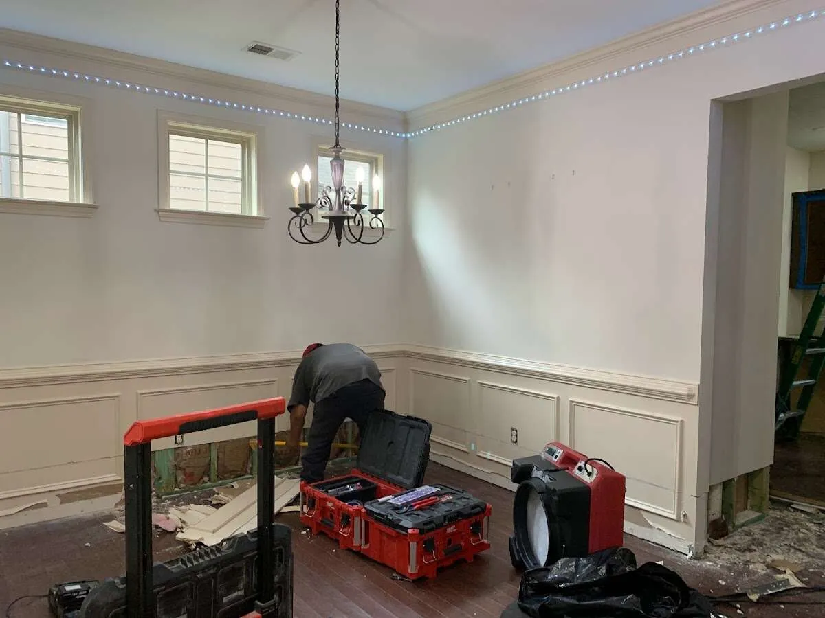 Restoration technician with professional equipment in Ayer